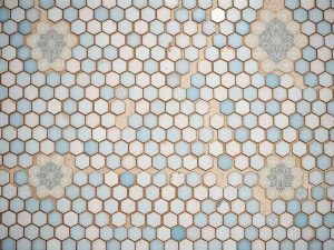 Vintage bathroom floor with penny and hexagon tiles in pink and blue