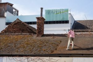 Flat roof being cleaned with soft wash method